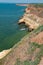 Steep clayey and shell rock shore overgrown with wild steppe vegetation on the island of Berezan, Ukraine