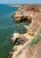 Steep clayey and shell rock shore overgrown with wild steppe vegetation on the island of Berezan, Ukraine