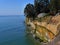 Steep cliff at  the Pacific Ocean with house perilously close to the abyss