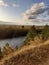 Steep cliff of pine forest overlooking the river.