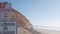 Steep cliff, rock or bluff, California coast. People walking, Torrey Pines beach