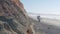 Steep cliff, rock or bluff, California coast. People walking, Torrey Pines beach