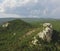 A steep cliff. A steep rocky mountain against a clear sky. A mountain peak