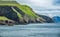 Steep coastline and boat in Faroe Islands