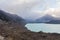 Steep high cliffs above the glacial lake. Southern Alps. South Island, New Zealand