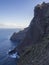 Steep high lava rock cliffs in tenerife blue sea horizon blue s