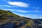 Steep hillside, blue sky in the background