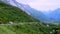 Steep mountain highway with a group of bikers on their bicycles going downhill with other traffic on the road.