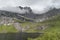 Steep rock crags on lake waters, at Stor lake ,  Lofoten, Norway