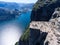 Steep rock Preikestolen over water of fjord Lysefjorden, natural attraction. Top view, flight above cliff. The Preacher`s Pulpit