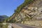 Steep rocky cliff alongside a road