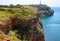 Steep rocky shore and vertical cliffs hanging over the water at Cape Kaliakra