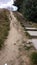 Steep sandy slope with wooden stairs