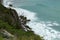 Steep shore of azure sea with trees