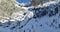 Steep Valley surrounded by Rocks and Mountains. Winter Landscape Aerial