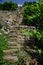 Steep vineyard stairs and vineyard walls made of natural stones under a blue sky