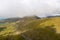 Steep and winding mountain road leading to the top of Connor Pass on the Dingle Peninsula