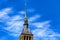 Steeple of Mont Saint-Michel abbey in France against blue sky