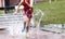 Steeplechase runner splashing in water