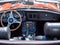 The steering wheel and dashboard of an antique classic car