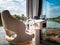 Steering wheel and driver seat on houseboat or floating house on a river, close up view