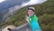 Stegastein viewpoint, Norway - July 22, 2018: Young traveller taking selfie on the top of view point with Beautiful