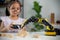 STEM education concept. Asian students learn at home by coding robot arms in STEM, mathematics engineering science technology