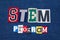 STEM PROGRAM text word collage, colorful fabric on blue denim, science technology engineering and mathematics