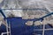 Stem of a tourist ferry on Lake Zurich in Switzerland. White plastic chairs are arranged to give view over the lake.