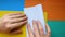 Step 1. female hands make paper boat. Step-by-step instructions on how to make origami paper ship.