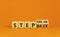 Step back or forward symbol. Concept words Step back Step Forward on wooden cubes. Beautiful orange table orange background.