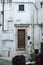 Step into History with Ostuni\\\'s White Building Stunning Wooden Door with Antique Charm