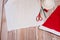 Step by step instructions. Step 11. Master class on creating a red hat of Santa Claus. A nearly finished Santa hat, scissors, a