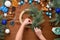 step-by-step process of making a Christmas tree wreath at home from spruce branches, oranges and Christmas balls in the silver and