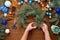 step-by-step process of making a Christmas tree wreath at home from spruce branches, oranges and Christmas balls in the silver and