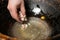 Step-by-step process and stages of cooking oriental cuisine - pilaf. The cook puts fat tail  in a cauldron.