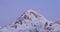 Stepantsminda, Gergeti, Georgia. Flock Of Birds Flies Over The Peak Of Mount Kazbek. Mount Covered Snow In Winter Season