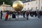 Stephan Balkenhol - Sphaera, a sculpture of a man on a golden sphere on Kapitelplatz in Salzburg