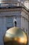 Stephan Balkenhol - Sphaera, a sculpture of a man on a golden sphere on Kapitelplatz in Salzburg