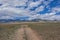 Steppe dirt road sky mountains