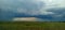 Steppe expanses of the country of the Great Steppe during a thunderstorm. Village from afar in rainy weather.