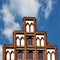 Stepped gable on a house in a northern German old town in front of blue sky with white clouds