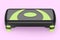 Stepper for fitness and green step platform for aerobics isolated on pink