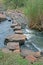 STEPPING STONES ACROSS A FLOWING RIVER