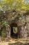 Steps in the arch of an ancient ruined fortress in the green jungle