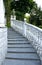 Steps of the classic staircase with white balusters go up