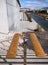 Steps down, crossed by shadows, on a sunny day at the Stavros Niarchos Cultural Center in Athens, Greece