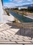 Steps down, crossed by shadows, on a sunny day at the Stavros Niarchos Cultural Center in Athens, Greece