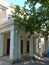 Steps leading to the entrance to the yellow building with huge white columns and pillars