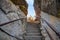 Steps between rocks on the top of mountain at sunset in autumn